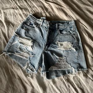 Mid Rise Medium Wash Ripped Jean Shorts